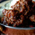 Close-up Indian-inspired beef vindaloo curry featuring a title overlay.