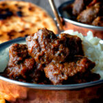 Indian-inspired beef vindaloo curry with rice featuring a title overlay.