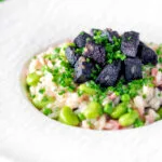 Black pudding risotto with bacon, broad beans and garden peas.
