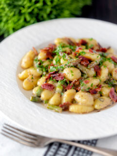 Creamy blue cheese gnocchi with stilton, asparagus and bacon.