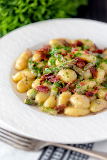 Creamy blue cheese gnocchi with stilton, asparagus and bacon.