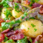 Close up creamy blue cheese gnocchi with stilton, asparagus and bacon.