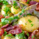 Close up creamy blue cheese gnocchi with stilton, asparagus and bacon featuring a title overlay.