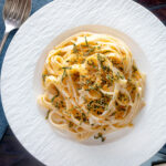 Overhead blue cheese pasta with fettuccini and a crispy golden sage crumb featuring a title overlay.