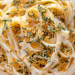 Close up overhead blue cheese pasta with fettuccini and a crispy golden sage crumb featuring a title overlay.