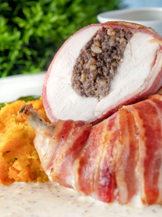 Close-up bacon-wrapped chicken Balmoral stuffed with haggis and a whisky cream sauce.