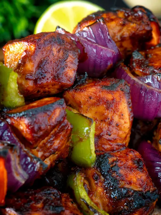 Close up chicken shashlik kebab sticks with peppers and onions.