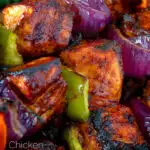 Close up chicken shashlik kebab sticks with peppers and onions featuring a title overlay.