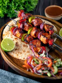 Chicken shashlik kebab sticks with chapatis and kachumber salad.