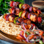 Spicy chicken shashlik kebab sticks with chapatis and kachumber salad.