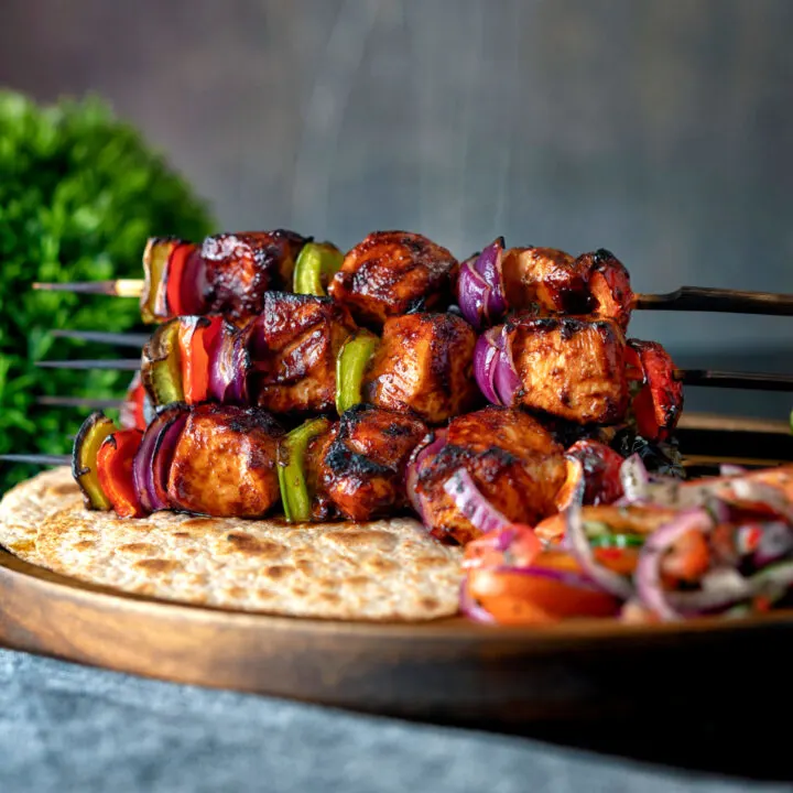 Spicy grilled chicken shashlik kebab sticks with chapatis, kachumber salad.