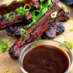 Chinese takeaway style spare ribs with a dipping sauce featuring a title overlay.