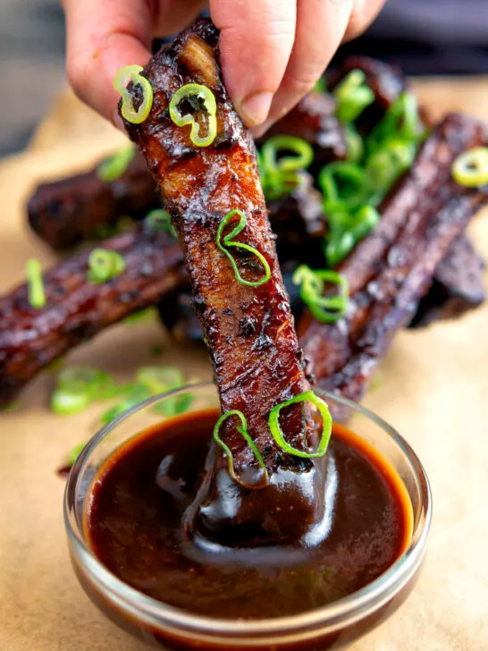 Chinese takeaway style spare ribs dipped into sauce.