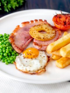 Gammon steak, pineapple, egg, chips with tomato and peas.