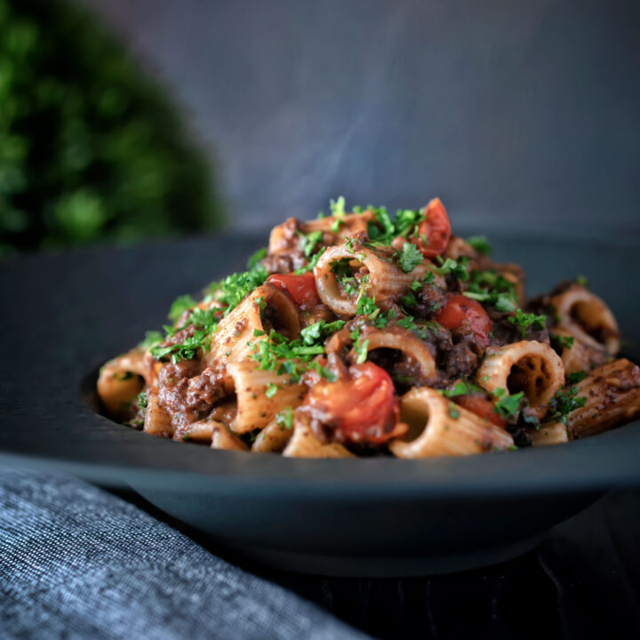 Leftover haggis pasta bolognese with mezzi rigatoni and cherry tomatoes.