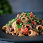 Haggis pasta bolognese with mezzi rigatoni in red wine sauce with cherry tomatoes.