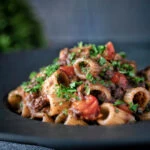 Haggis pasta bolognese with mezzi rigatoni in red wine sauce with cherry tomatoes.