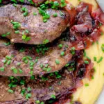 Close up overhead fried lambs liver and port onions on polenta.