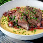 Fried lambs liver and port onions on polenta with chives.