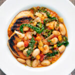Overhead quick Italian ribollita bean soup from Tuscany with toasted bread.