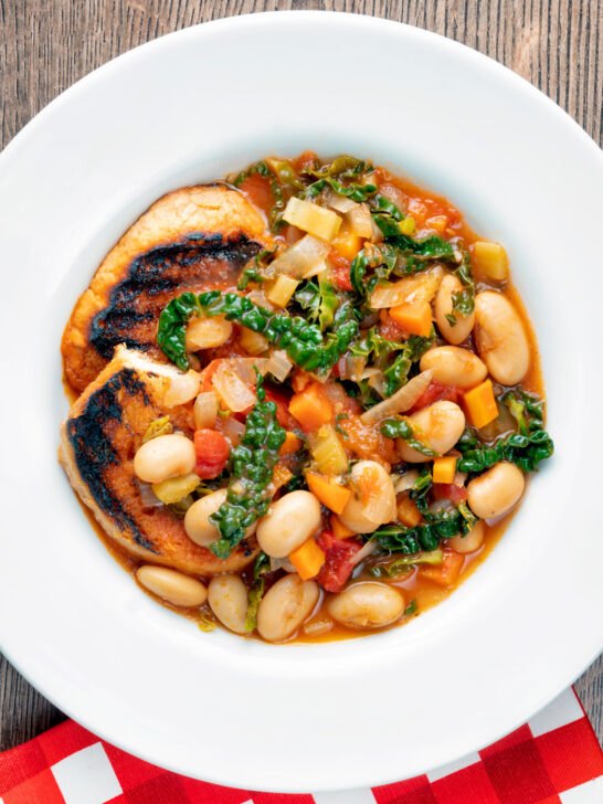 Overhead quick Italian ribollita bean soup from Tuscany with toasted bread.