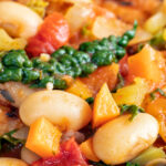 Close-up Italian ribollita bean soup from Tuscany with toasted bread featuring a title overlay.