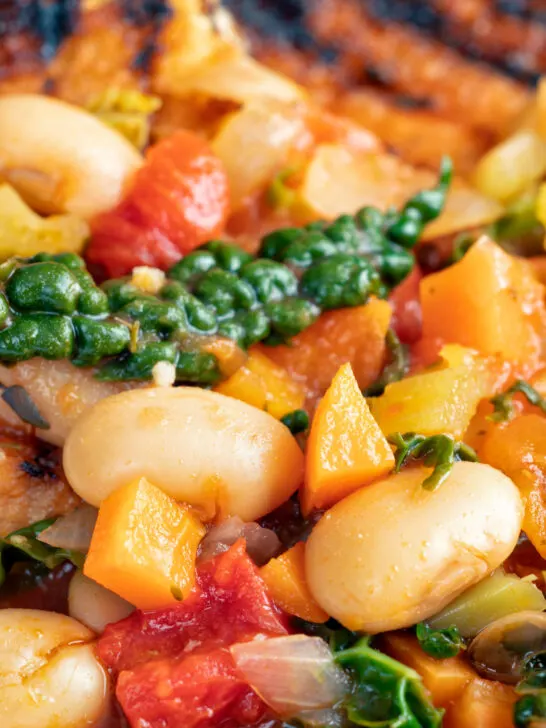 Close-up Italian ribollita bean soup from Tuscany with toasted bread featuring a title overlay.