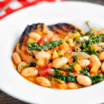 Quick Italian ribollita bean soup from Tuscany with toasted bread featuring a title overlay.