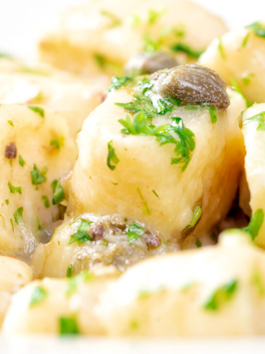 Close-up ricotta cheese gnocchi with caper butter sauce.