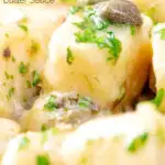 Close-up ricotta cheese gnocchi with caper butter sauce featuring a title overlay.