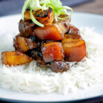 Sticky pork belly with pineapple and soy sauce served with rice.