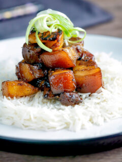 Sticky pork belly with pineapple and soy sauce served with rice.