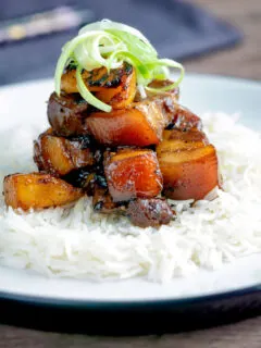 Sticky pork belly with pineapple and soy sauce served with rice.