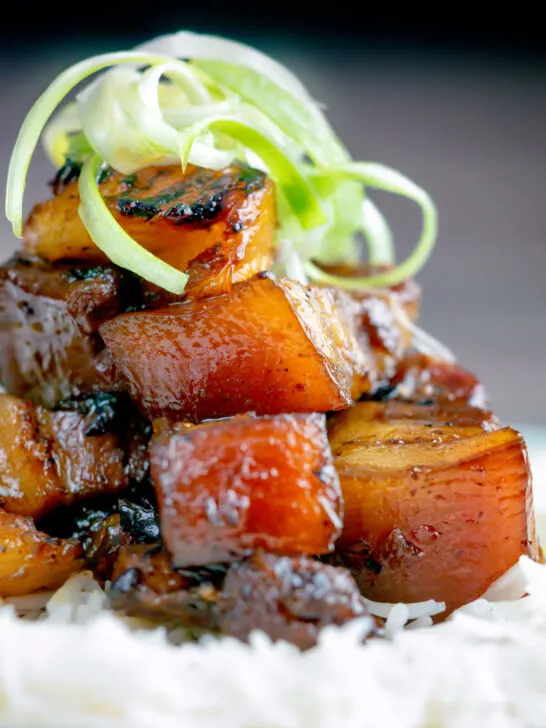 Close up sticky twice cooked pork belly with pineapple and soy sauce.