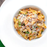 Overhead wild boar ragu or cinghiale al ragu with grated parmesan cheese.