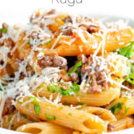 Close up wild boar ragu or cinghiale al ragu with grated parmesan cheese featuring a title overlay.