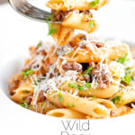 Wild boar ragu or cinghiale al ragu with penne pasta on a fork featuring a title overlay.