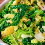 Close-up sauteed buttered savoy cabbage with fennel seeds.