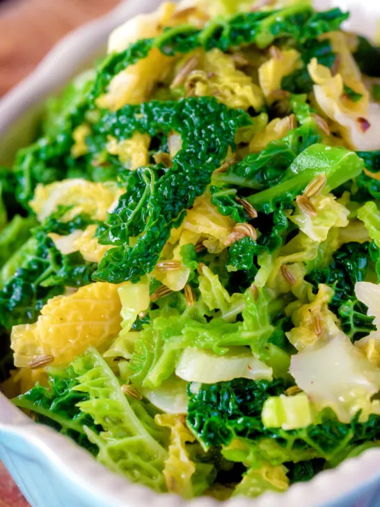 Close-up sauteed buttered savoy cabbage with fennel seeds.