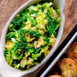 Overhead sauteed buttered savoy cabbage with fennel seeds featuring a title overlay.