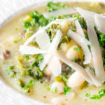 Close-up quick cabbage and cannellini bean soup with potatoes and capers.