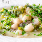 Close-up vegan cabbage and cannellini bean soup with potatoes and capers featuring a title overlay.