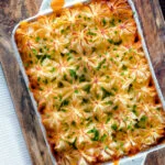 Overhead fish finger and baked bean pie topped with cheesy mash.