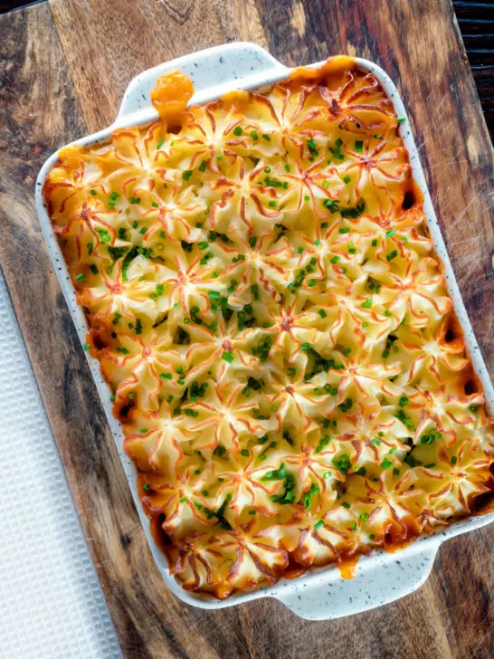 Overhead fish finger and baked bean pie topped with cheesy mash.