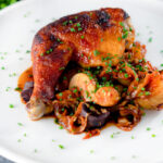 Kimchi chicken leg stew with potatoes, carrots and snipped chives.