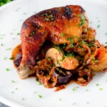 Kimchi chicken leg stew with potatoes, carrots and snipped chives.