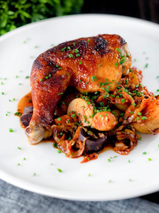 Kimchi chicken leg stew with potatoes, carrots and snipped chives.