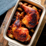 Overhead roasted kimchi chicken leg stew with potatoes and carrots.