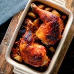 Overhead roasted kimchi chicken leg stew with potatoes and carrots.