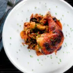 Overhead kimchi chicken leg stew with potatoes and carrots.